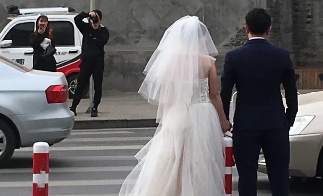 男女半裸裹床单躺斑马线拍婚纱照，如何惩罚违反交通行为？